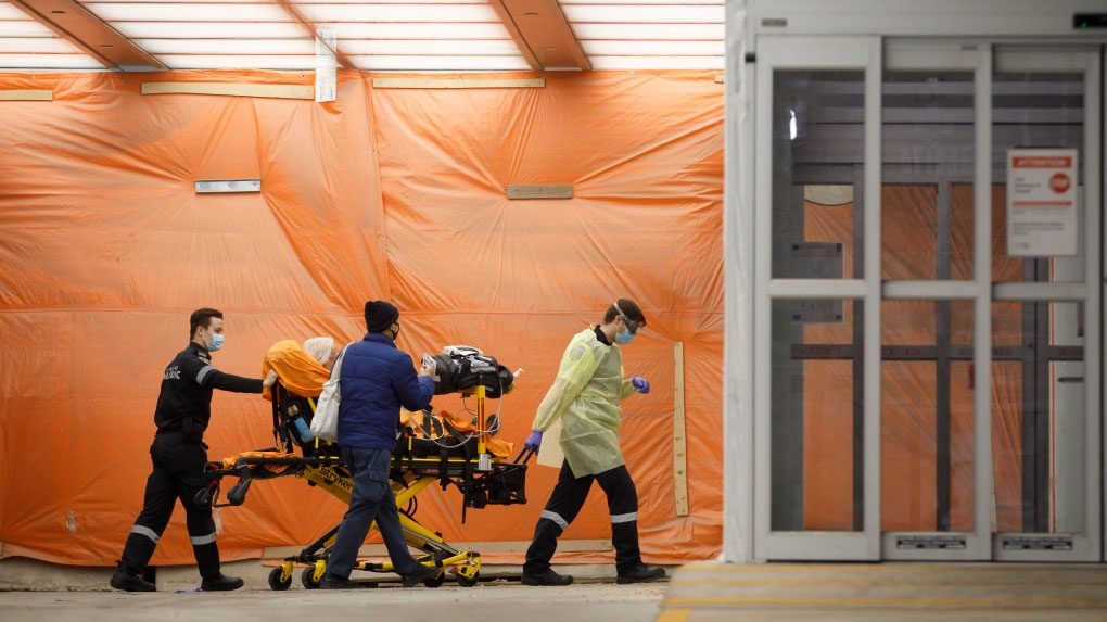 Paramedics wheel a patient into the emergency department at Mount Sinai Hospital in Toronto